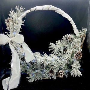 White Wreath with frosted foliage with lights